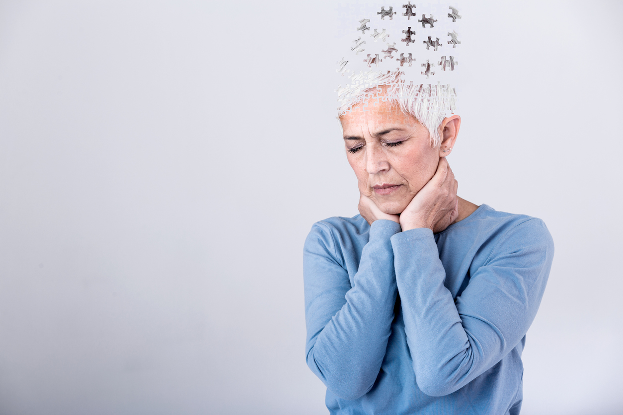 Memory loss due to dementia. Senior woman losing parts of head as symbol of decreased mind function. Senior woman losing parts of head feeling confused as symbol of decreased mind function.